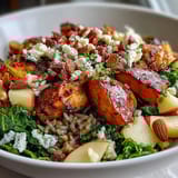A freshly tossed Harvest Bowl with wild rice, tender chicken, roasted sweet potatoes, and crunchy almonds, drizzled with tangy balsamic dressing.