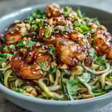 Freshly chopped cilantro and lime wedges garnish a serving of Asian Noodle Bowl, ready for a quick and easy weeknight dinner.