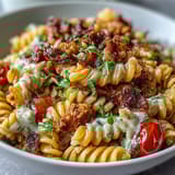 Colorful Easy Taco Pasta Salad with cherry tomatoes, black beans, and cheddar cheese in a creamy taco dressing, perfect for summer potlucks.