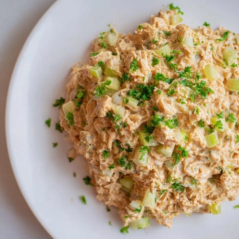 Perfect for meal prep, this easy pescatarian lunch features crisp celery, a zesty lemon wedge garnish, and optional parsley for a bright finish.  