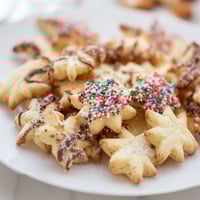 Golden Spritz Cookies, beautifully shaped and lightly browned, waiting to be enjoyed.