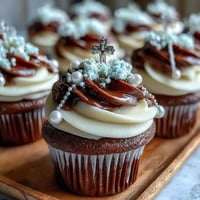 Elegant mini vanilla cupcakes topped with creamy buttercream and delicate fondant rosary toppers for a First Communion celebration.